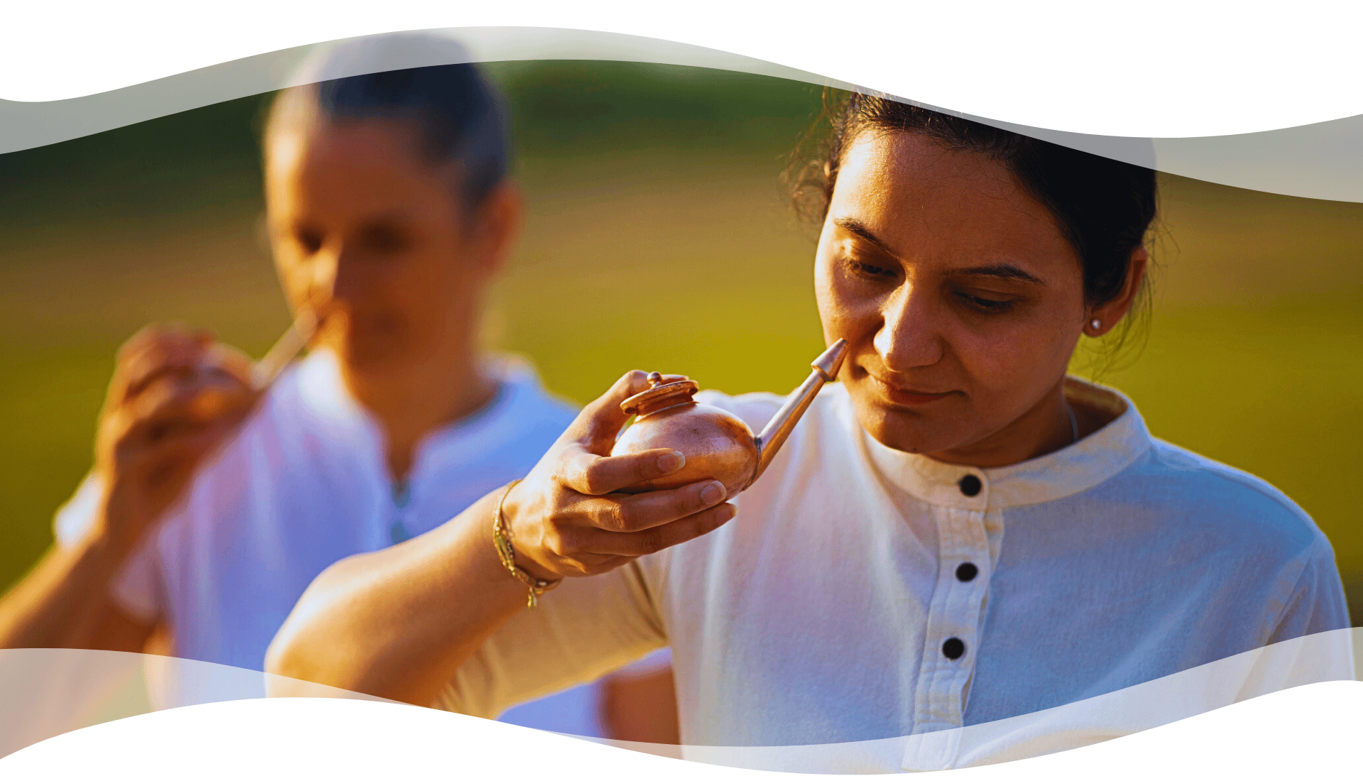 Participants practicing Jala Neti using copper pots during a classical Hatha Yoga cleansing session outdoors