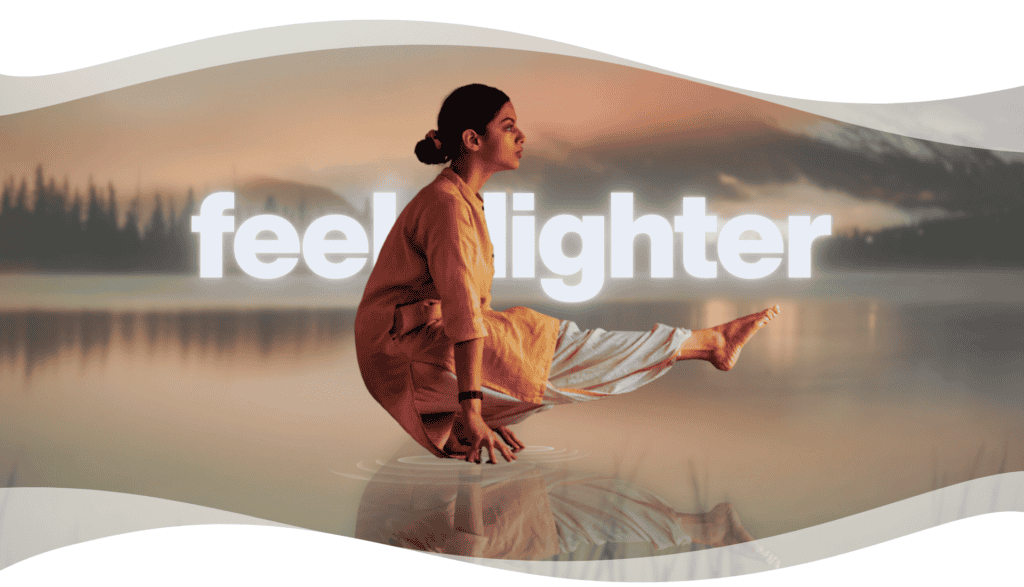 Woman practicing Angamardana beside a calm lake, expressing strength, balance, and lightness through yogic movement